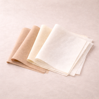 Three folded fabric swatches in beige, cream, and white on a light beige background