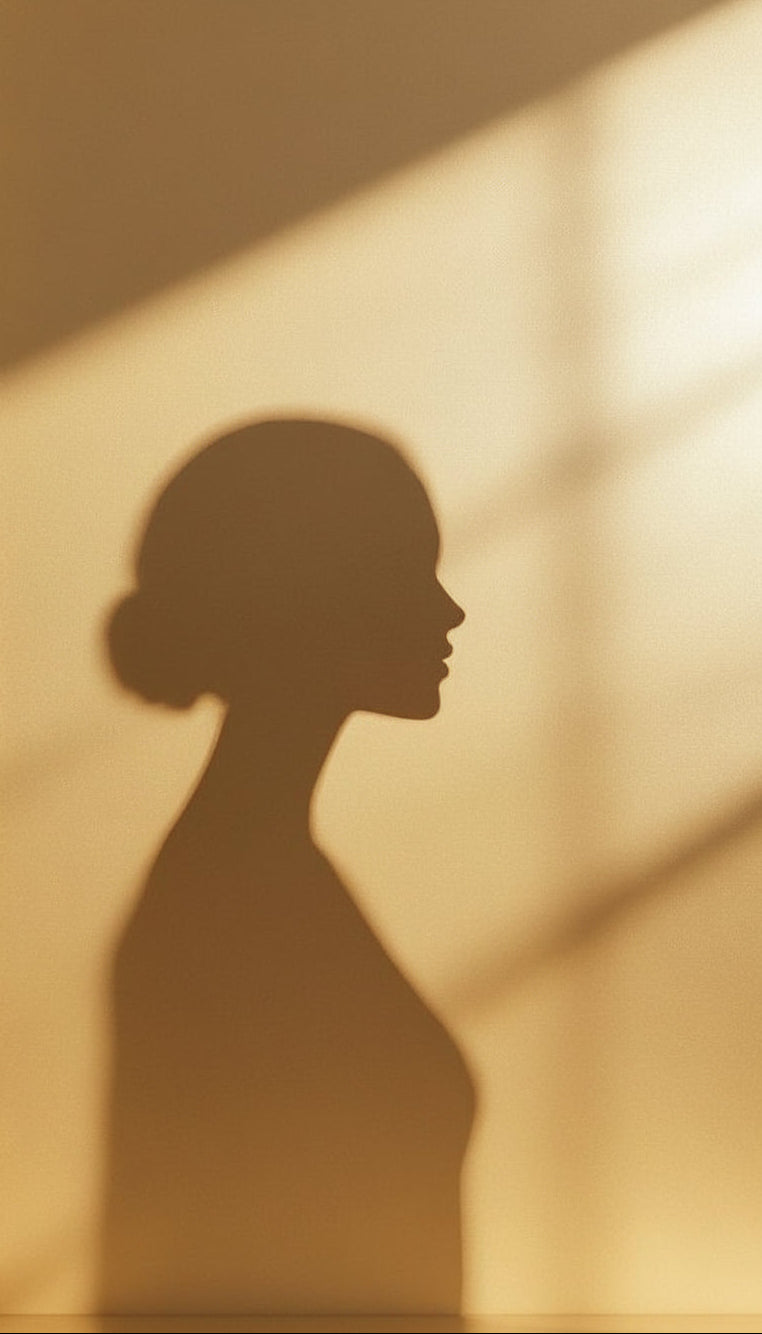 Shadow of a person on a wall with a warm, beige background