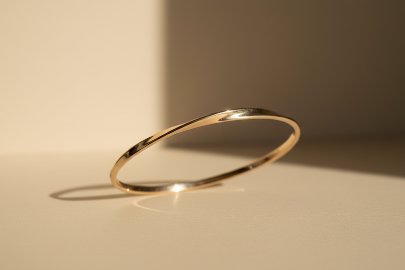 Gold bracelet on a beige background